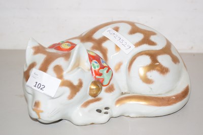 Lot 102 - An Oriental pottery model of a sleeping cat