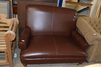 Lot 310 - A small brown leather sofa