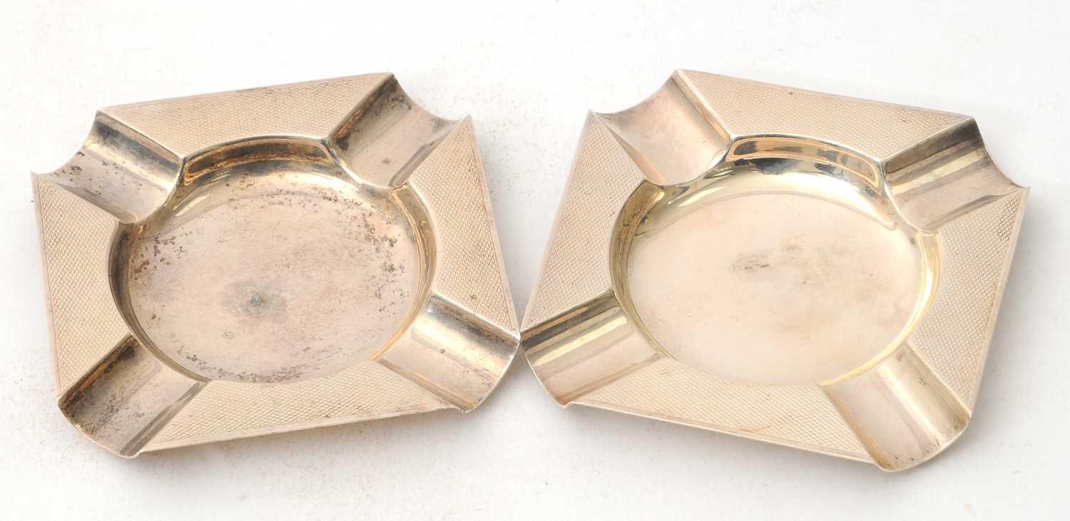 Lot 63 - A pair of silver ashtrays of shaped square...