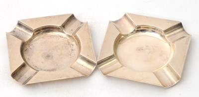 Lot 63 - A pair of silver ashtrays of shaped square...