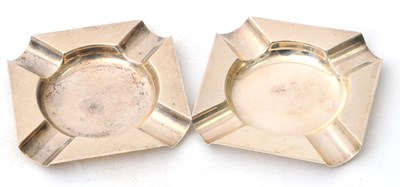 Lot 63 - A pair of silver ashtrays of shaped square...