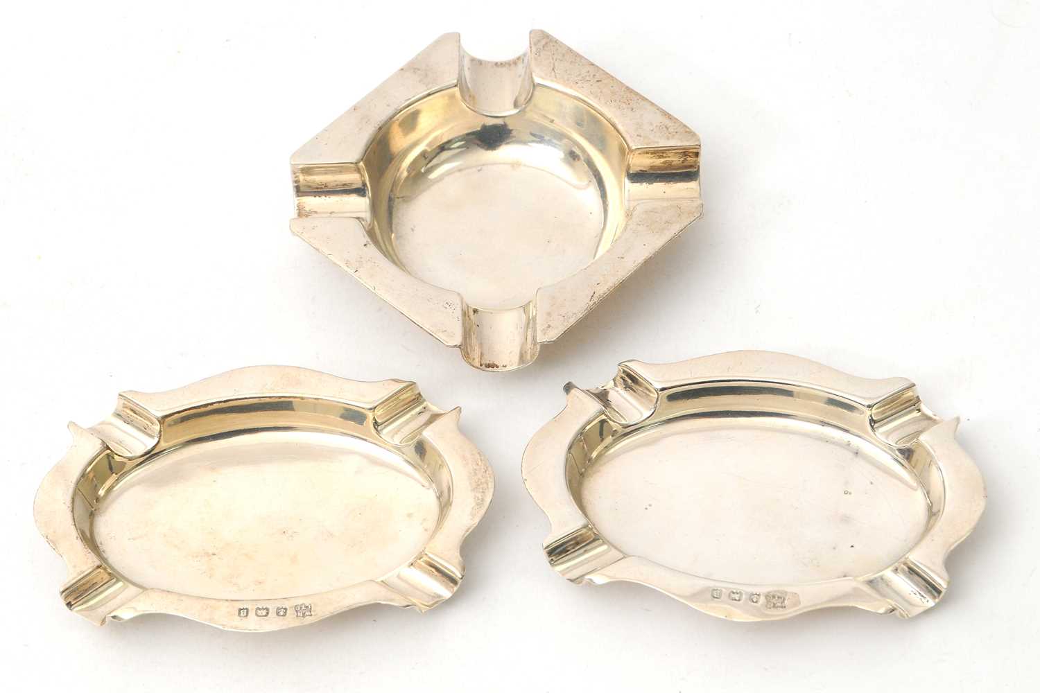 Lot 83 - A pair of George V silver ashtrays of plain...