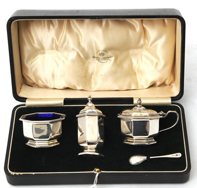 Lot 88 - A cased Art Deco three piece silver condiment...