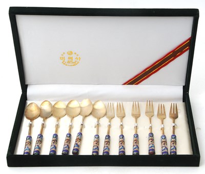 Lot 89 - A Korean twelve piece spoon/fork set, each...