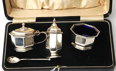 Lot 95 - A cased Art Deco three piece silver condiment...