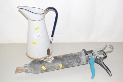 Lot 521 - An enamel jug and a brick pointing tool