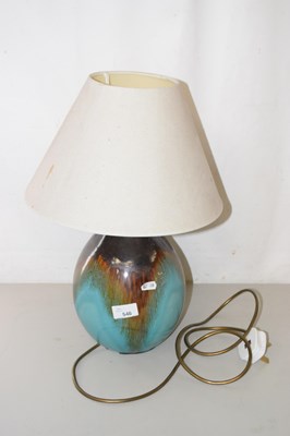 Lot 546 - A treacle glazed pottery table lamp