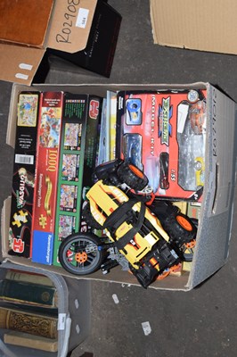 Lot 585 - A box of various jigsaw puzzles, toys etc