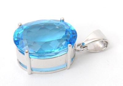 Lot 43 - A 9ct white gold topaz pendant, the oval...