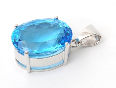 Lot 43 - A 9ct white gold topaz pendant, the oval...