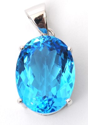 Lot 43 - A 9ct white gold topaz pendant, the oval...