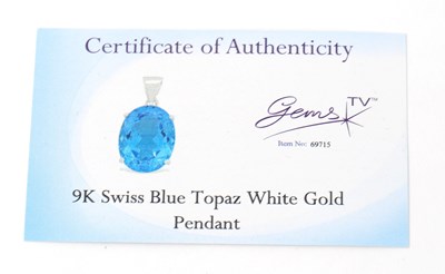 Lot 43 - A 9ct white gold topaz pendant, the oval...