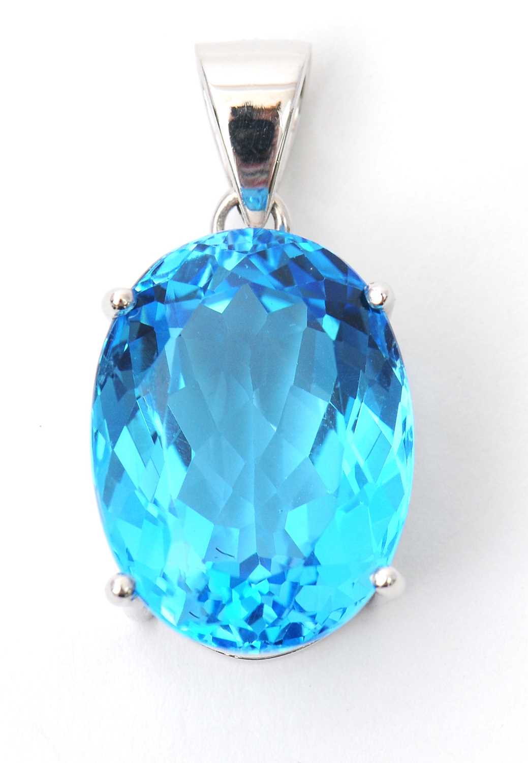 Lot 43 - A 9ct white gold topaz pendant, the oval...