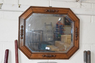 Lot 881 - An octagonal oak framed wall mirror