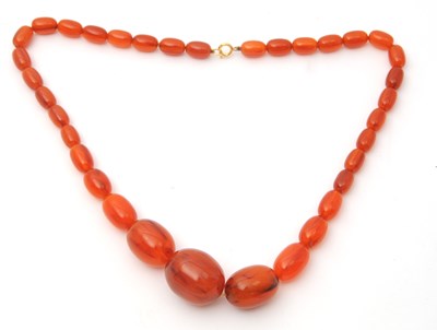 Lot 134 - An amber bead necklace, with graduated oval...