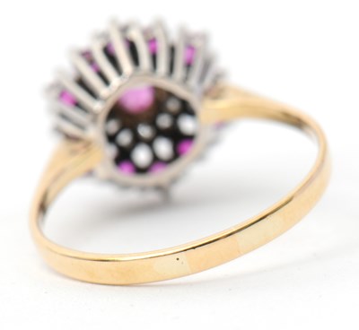 Lot 27 - A ruby and diamond cluster ring, with central...