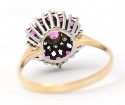 Lot 27 - A ruby and diamond cluster ring, with central...