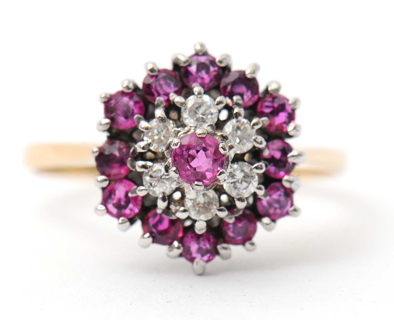 Lot 27 - A ruby and diamond cluster ring, with central...