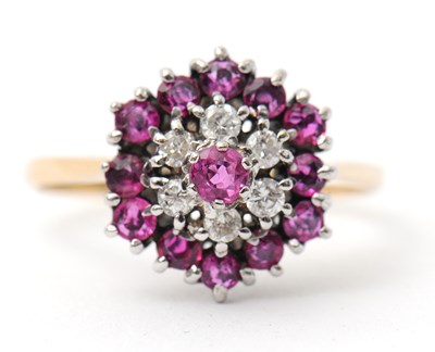 Lot 27 - A ruby and diamond cluster ring, with central...