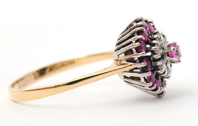 Lot 27 - A ruby and diamond cluster ring, with central...