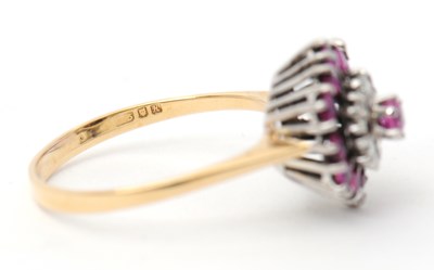 Lot 27 - A ruby and diamond cluster ring, with central...