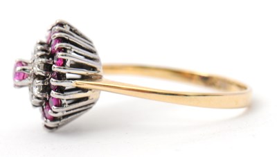 Lot 27 - A ruby and diamond cluster ring, with central...