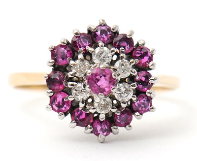 Lot 27 - A ruby and diamond cluster ring, with central...