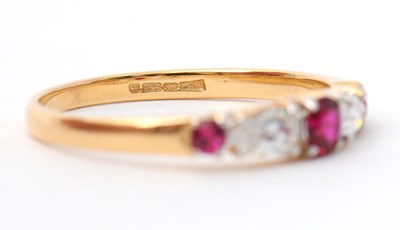 Lot 26 - A 14ct ruby and diamond ring, with central...
