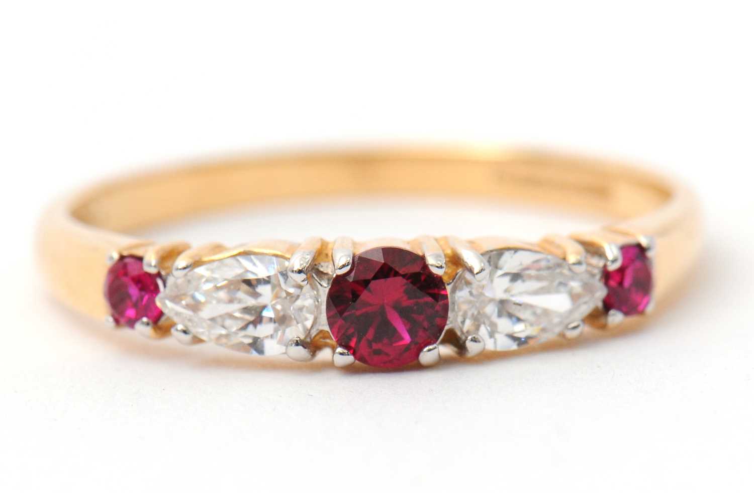 Lot 26 - A 14ct ruby and diamond ring, with central...