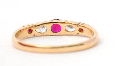 Lot 26 - A 14ct ruby and diamond ring, with central...