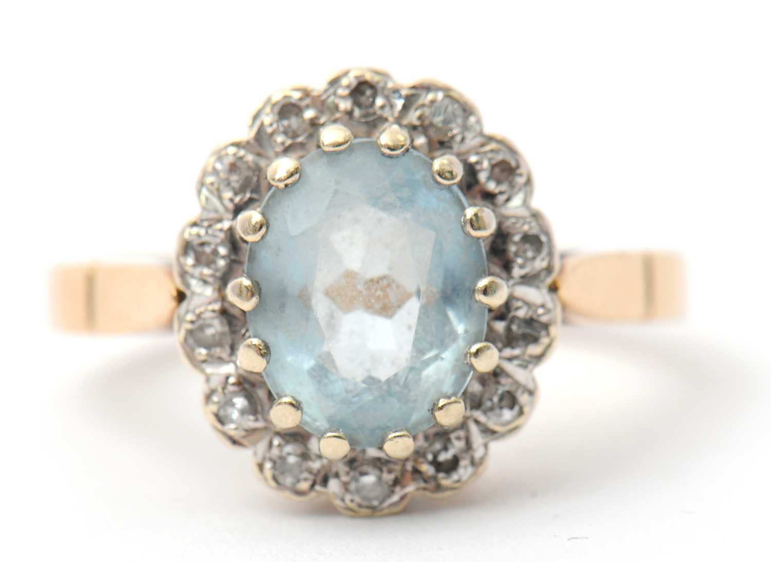 Lot 29 - A 9ct topaz and diamond cluster ring, the...