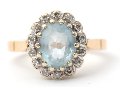 Lot 29 - A 9ct topaz and diamond cluster ring, the...