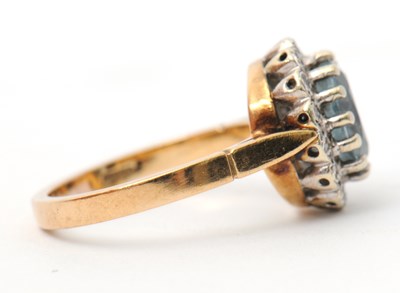 Lot 29 - A 9ct topaz and diamond cluster ring, the...
