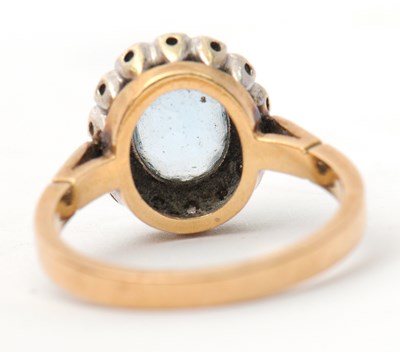 Lot 29 - A 9ct topaz and diamond cluster ring, the...