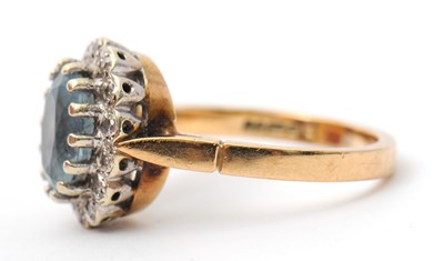 Lot 29 - A 9ct topaz and diamond cluster ring, the...