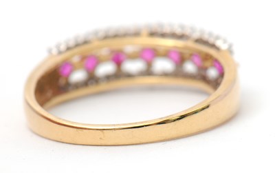 Lot 33 - A 9ct ruby and diamond ring, with central row...