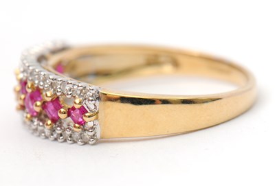 Lot 33 - A 9ct ruby and diamond ring, with central row...