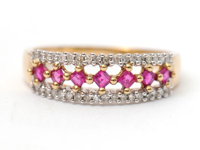 Lot 33 - A 9ct ruby and diamond ring, with central row...