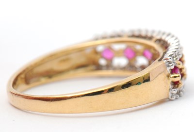 Lot 33 - A 9ct ruby and diamond ring, with central row...