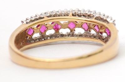 Lot 33 - A 9ct ruby and diamond ring, with central row...