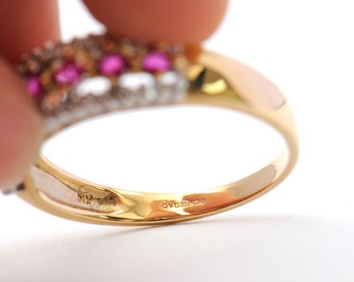 Lot 33 - A 9ct ruby and diamond ring, with central row...