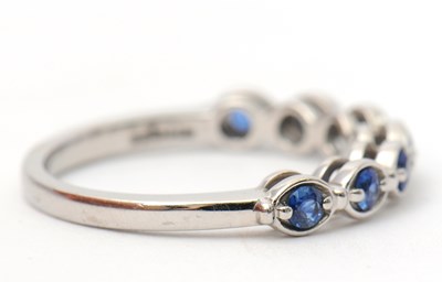 Lot 34 - A platinum sapphire ring, with seven round...