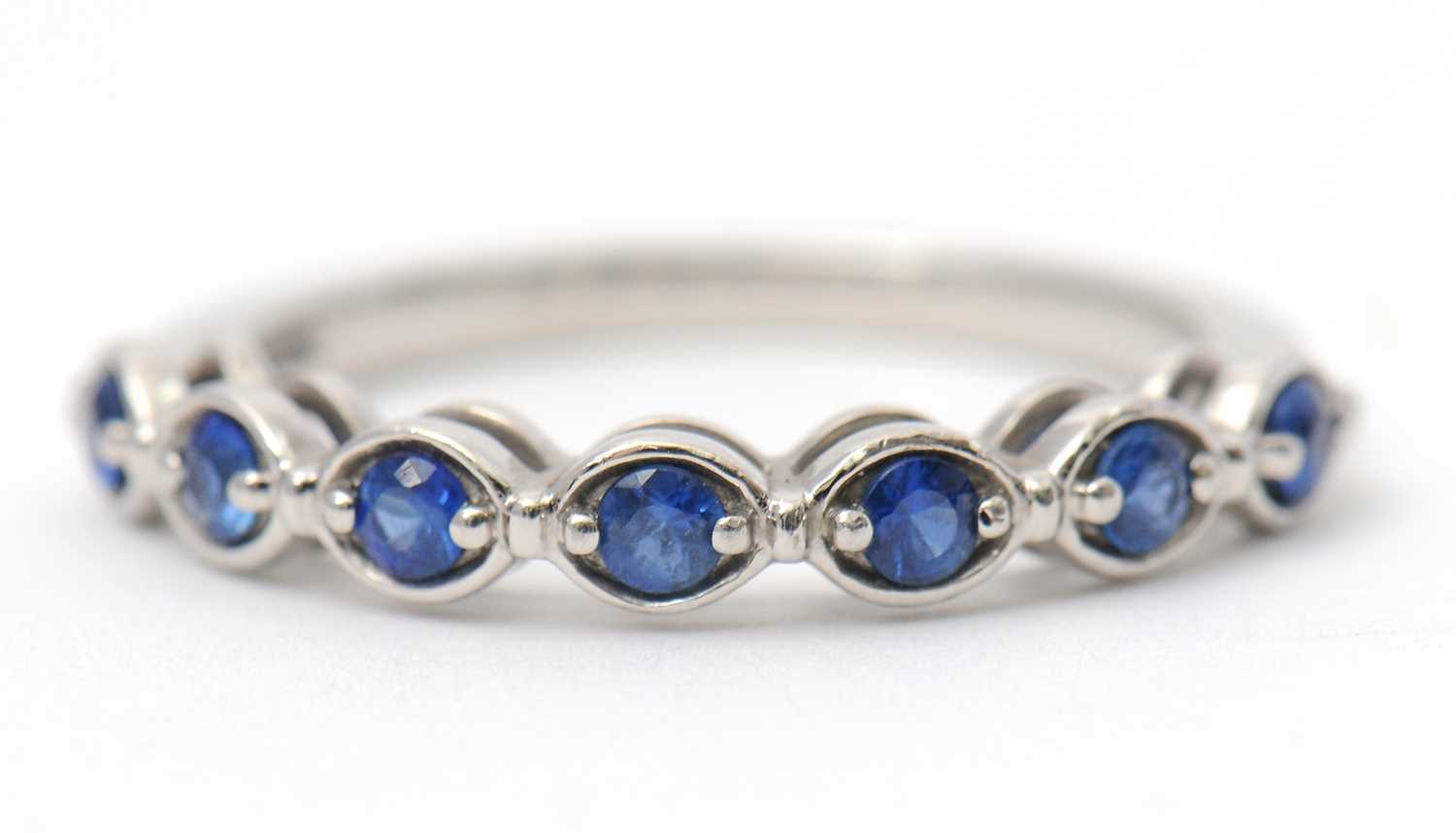 Lot 34 - A platinum sapphire ring, with seven round...