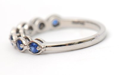 Lot 34 - A platinum sapphire ring, with seven round...