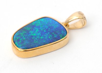 Lot 72 - A 9ct opal pendant, with off-oval opal in...