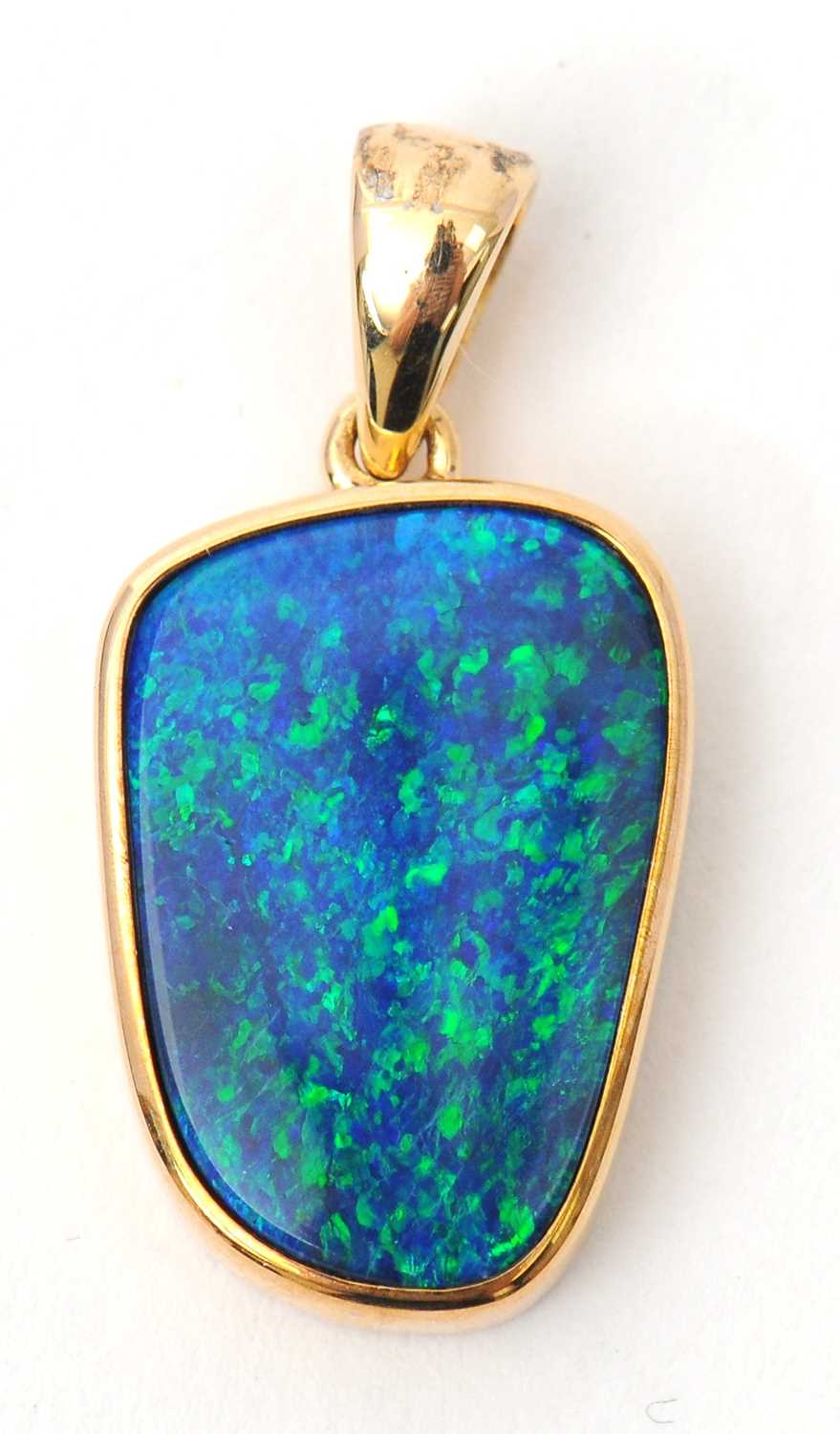 Lot 72 - A 9ct opal pendant, with off-oval opal in...