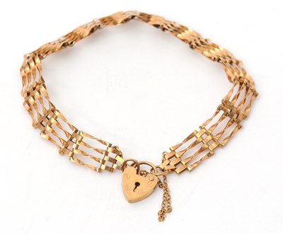 Lot 86 - A 9ct gate bracelet, 8.5mm wide, with padlock...