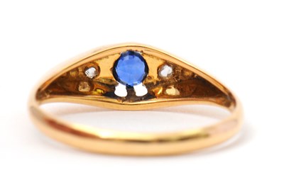 Lot 36 - An 18ct sapphire and diamond ring, with...