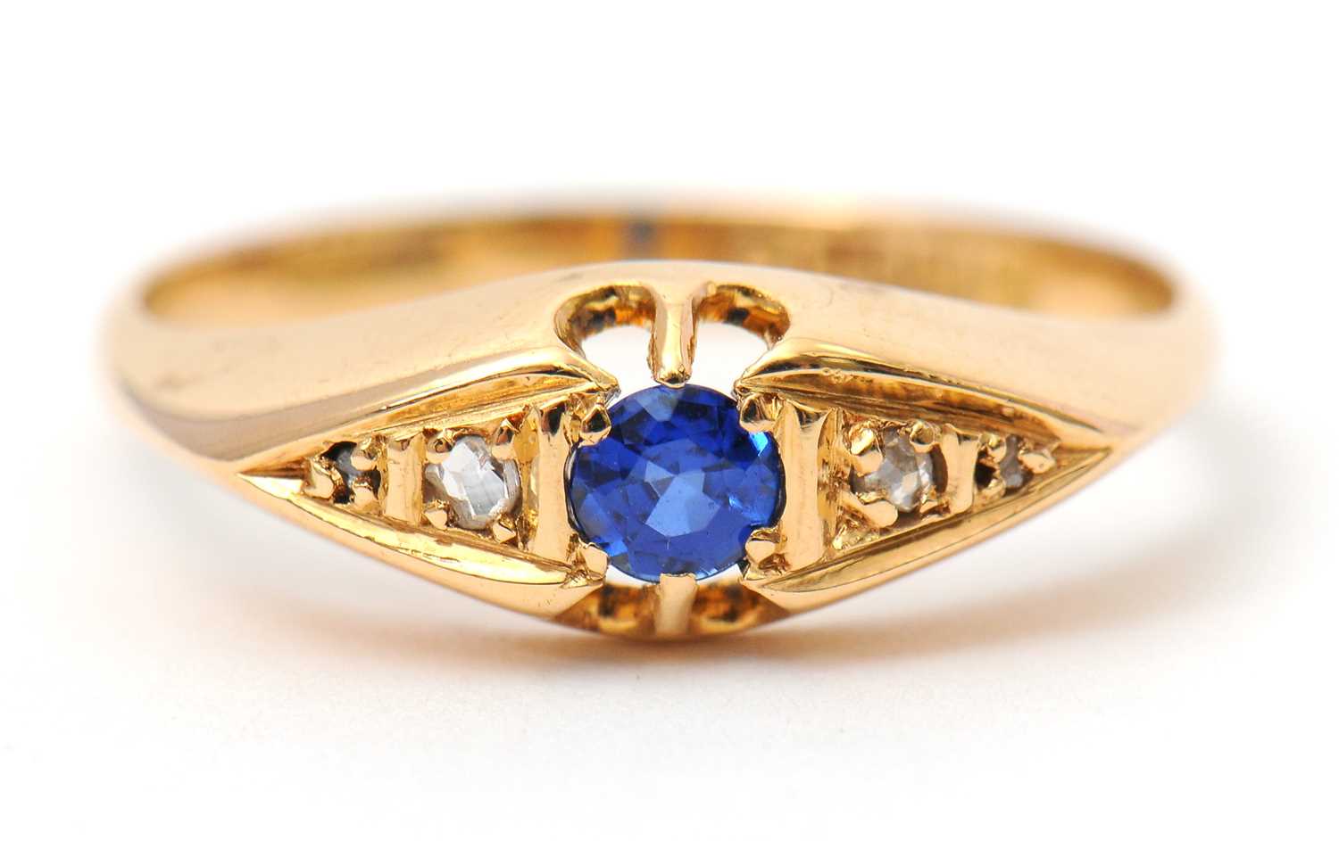 Lot 36 - An 18ct sapphire and diamond ring, with...