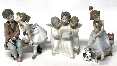 Lot 328 - Three Lladro models of children, two seated on...